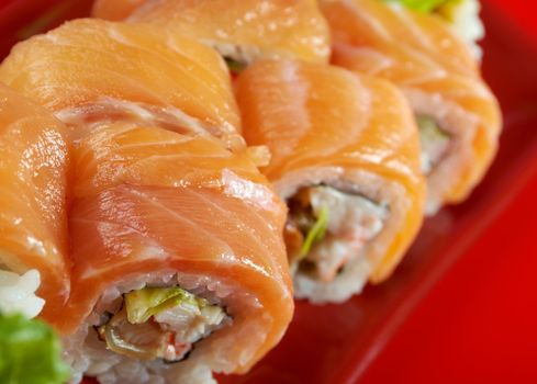 Uramaki. Philadelphia classic. Salmon, Philadelphia cheese, cucumber, avocado, tobiko. Japanese sushi