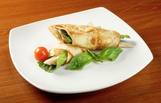 rolled pancakes stuffed chicken. Shallow depth-of-field.