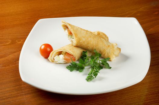 rolled pancakes stuffed chicken. Shallow depth-of-field.
