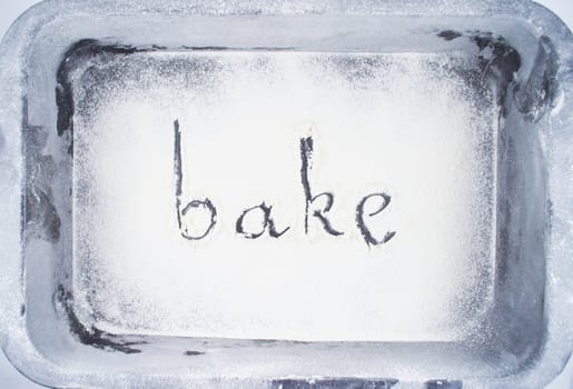 Inscription made by hand by sprinkled flour on a oven-tray