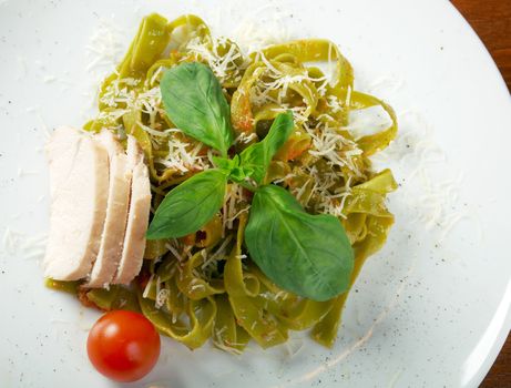 Pasta tagliatelle with pesto sauce basil and grated parmesan