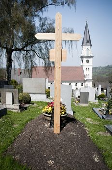 Fresh Grave with Church in Background, taken in Austria