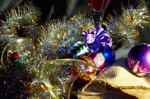 Empty and full glass,golden garland and Christmas balls