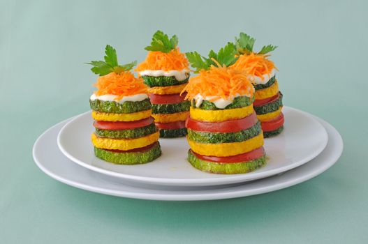 Pinnacles of yellow and green zucchini with tomato