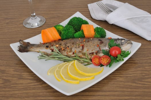 Baked sea bass in spices with broccoli and carrots