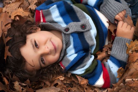 Happy child in the forest is having fun