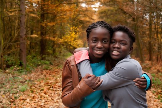 Happy girls in the forest are having fun