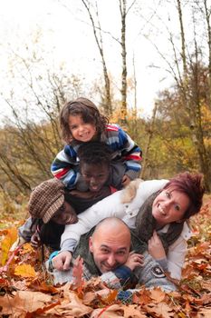 Happy family with foster children in the forest