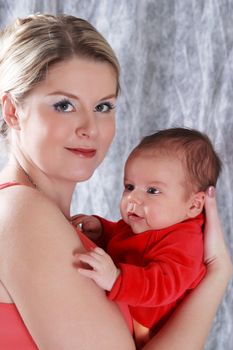 Mother with her newborn baby in home