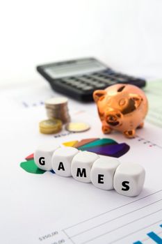 Games word on white bones. Piggybank on colorful business background