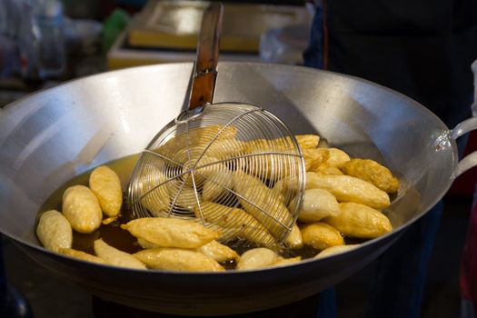 cooking, Deep frying meatballs in a huge wok