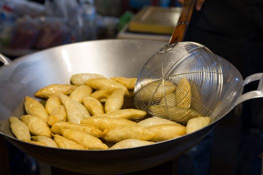 Cooking, Deep frying meatballs in a huge wok