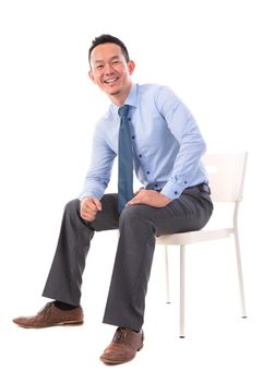 Full body Asian business man sitting on a chair over white background