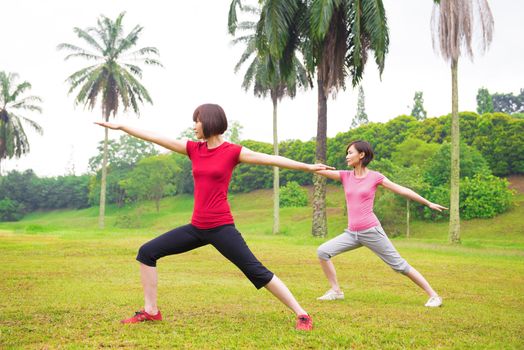 Asian girls practicing yoga outdoor green park
