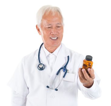 Asian senior doctor holding a bottle of pills, smiling isolated white background