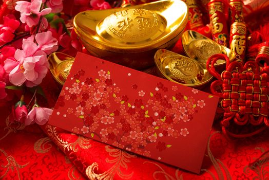 Chinese new year festival decorations, ang pow or red packet and gold ingots.