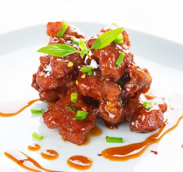 Spare ribs Chinese cuisine dish, close up delicious Asian food ready to serve in plate.