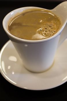 A cup of freshly made white coffee