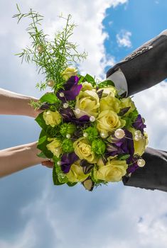 This image shows a bridal bouquet with arms