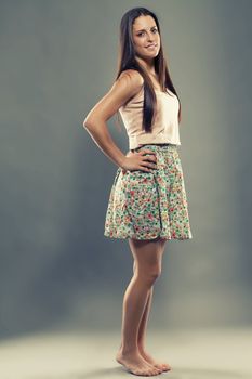 barefooted pretty brunette teenager wearing a summer dress