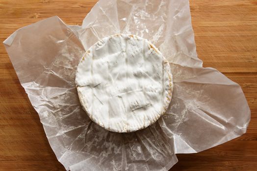 Camembert cheese on a wooden board