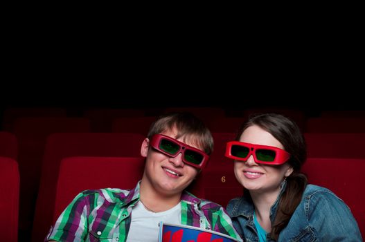 couple in a movie theater, watching a 3D movie