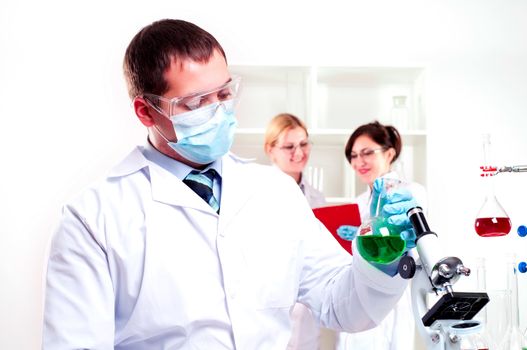 chemist working in the laboratory, mix liquid