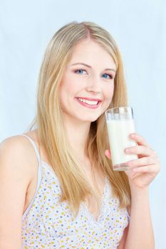 Happy blond hair woman holding glass of milk