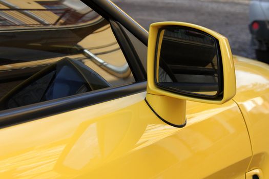 rear view mirror of yellow car