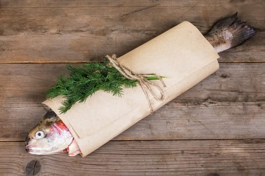 Fresh salmon on in the paper-bag on old wooden table
