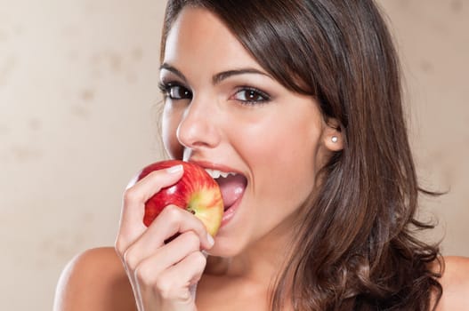 Portrait of pretty young woman eating an apple