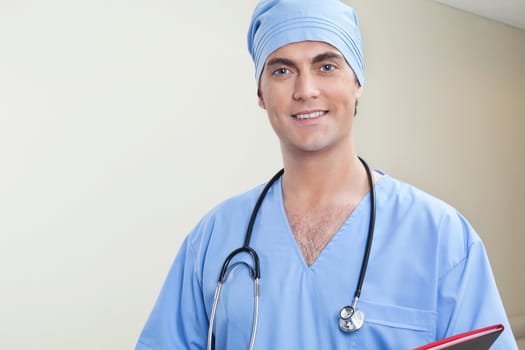 Young male doctor in hospital corridor