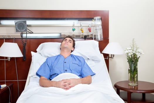 Thoughtful young patient lying on bed in hospital