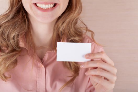 Image of smiling business woman holding her visiting card
