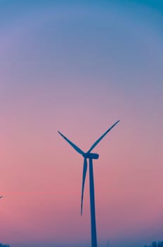 An image of windturbine during colorfull sunset