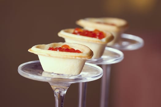 Tartlets with heart-shaped eggs on a glass base