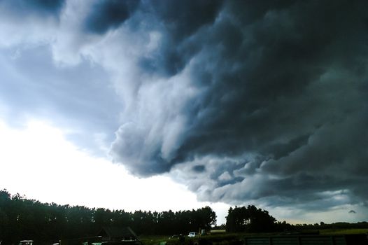 An image of Dark sky with storm clouds during sunset