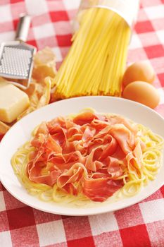 Pasta carbonara over red cloth