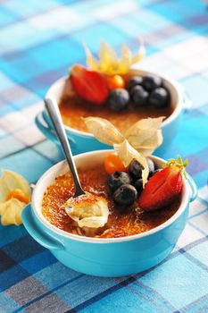 Creme brulee (cream brulee, burnt cream) with fruits and berries