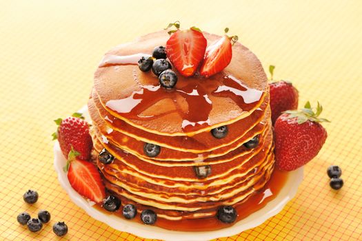 Delicious freshly prepared pancakes with strawberry and blueberries