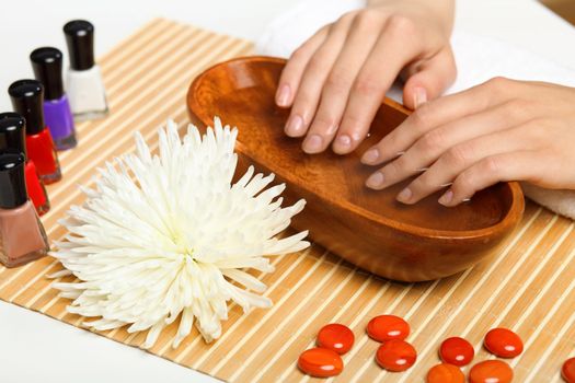 Young woman is getting manicure in a beauty salon