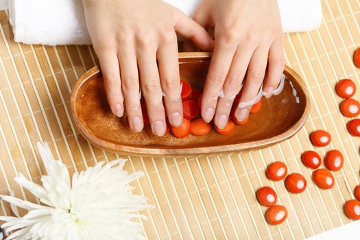 Young woman is getting manicure in a beauty salon