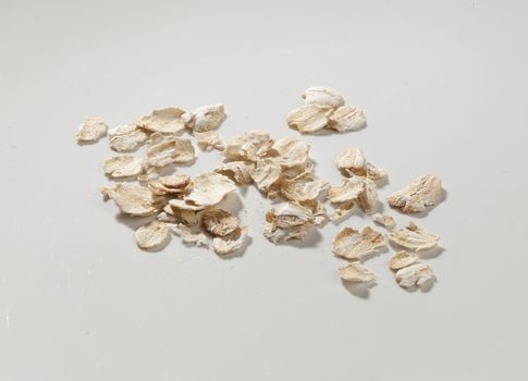 Handful of oat flakes on the grey background