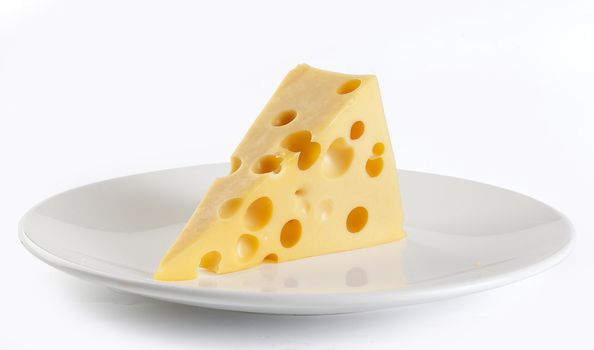 Piece of cheese on the white plate