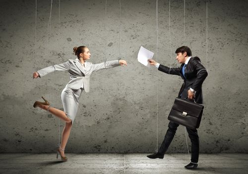 Image of businesspeople hanging on strings like marionettes. Conceptual photography