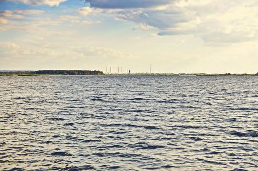 An image of Lake and factory in the foreground