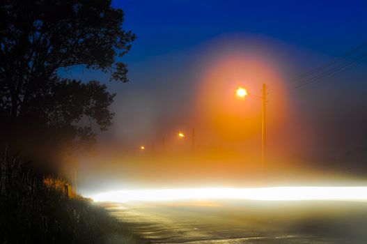 An image of road at night with fog