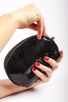 An image of womens hand and purse