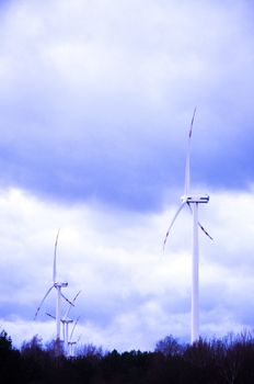 An image of windturbine generator over cloudy sky