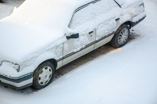 An image of car cover by snow